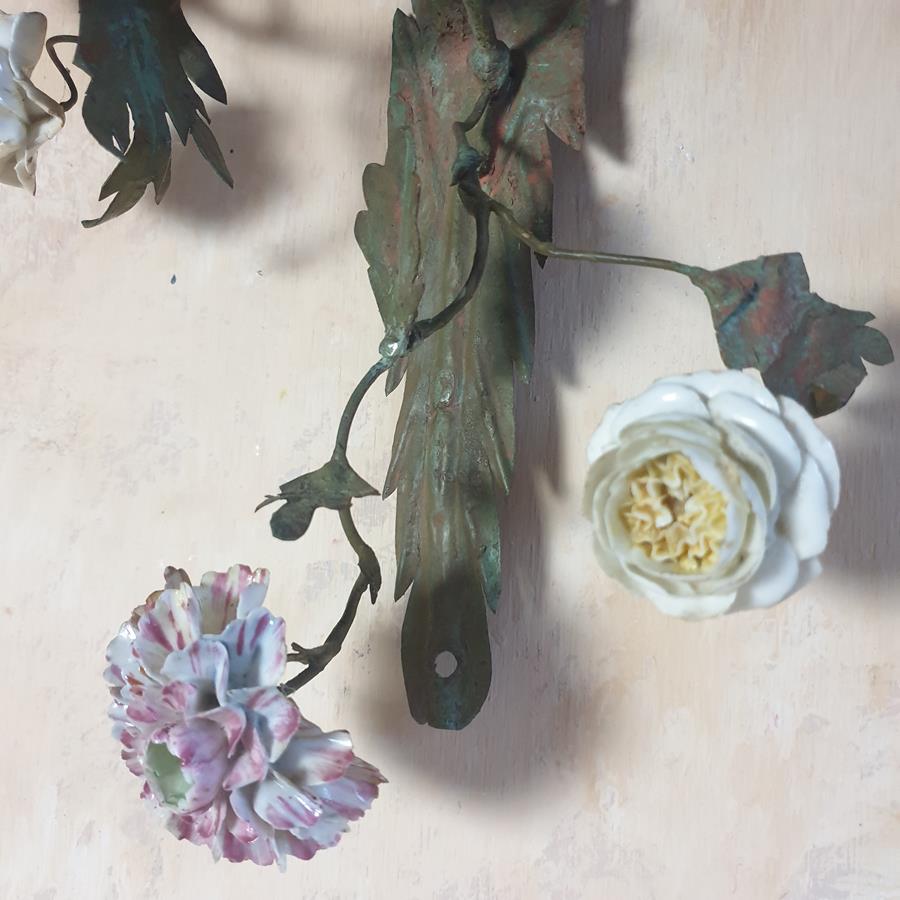 A pair of French painted tôle and porcelain wall-lights