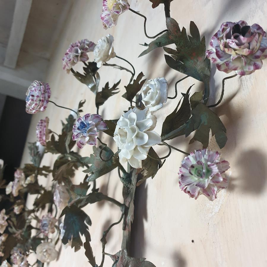 A pair of French painted tôle and porcelain wall-lights