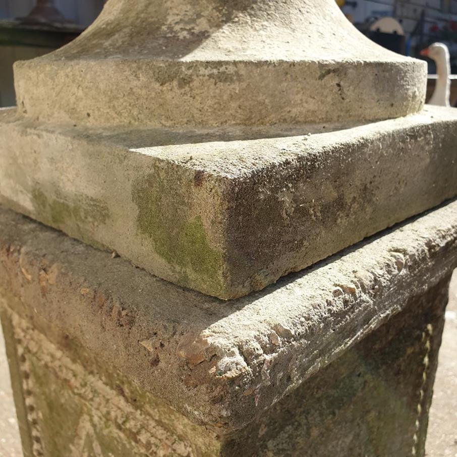 A Pair Of Rams Head Urns On Plinths