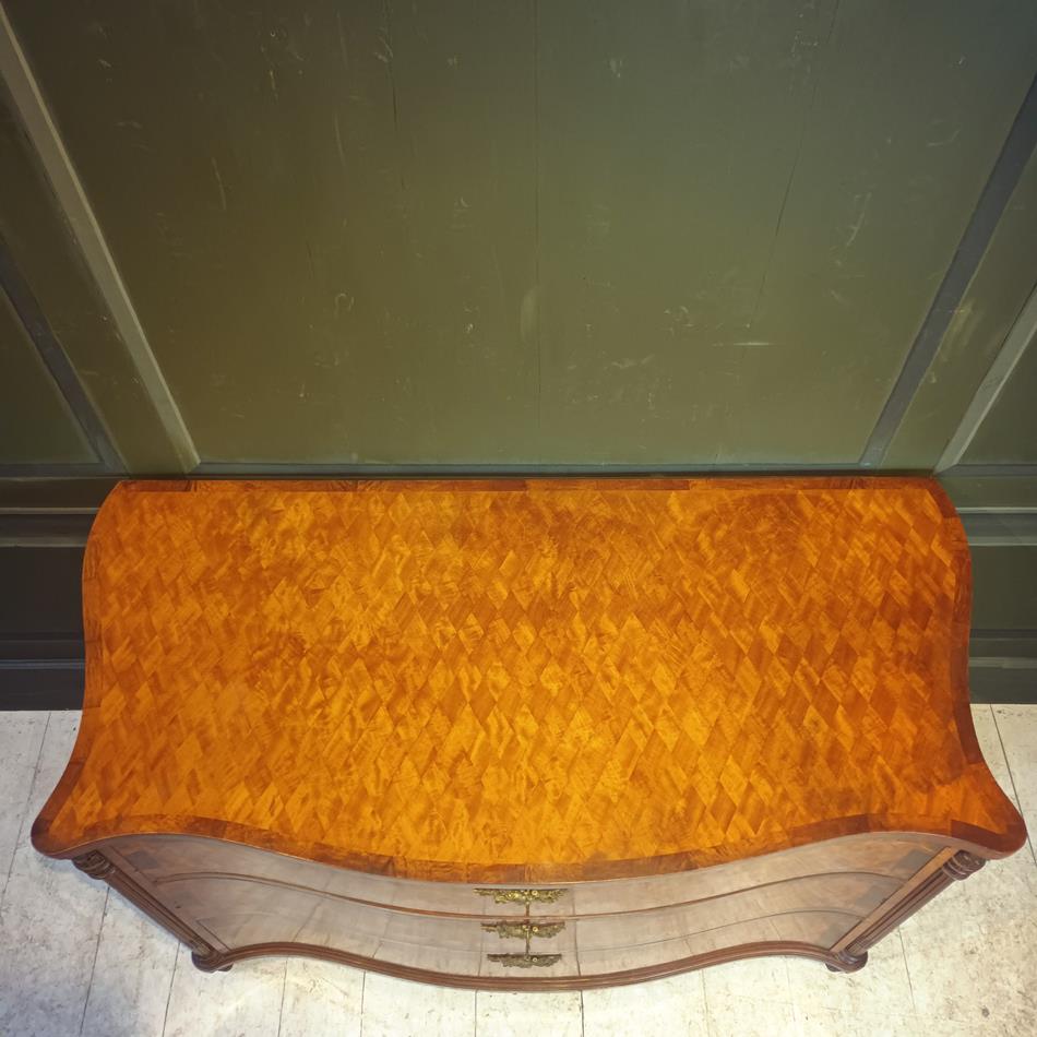 A Late 19th Century Serpentine Satinwood Commode