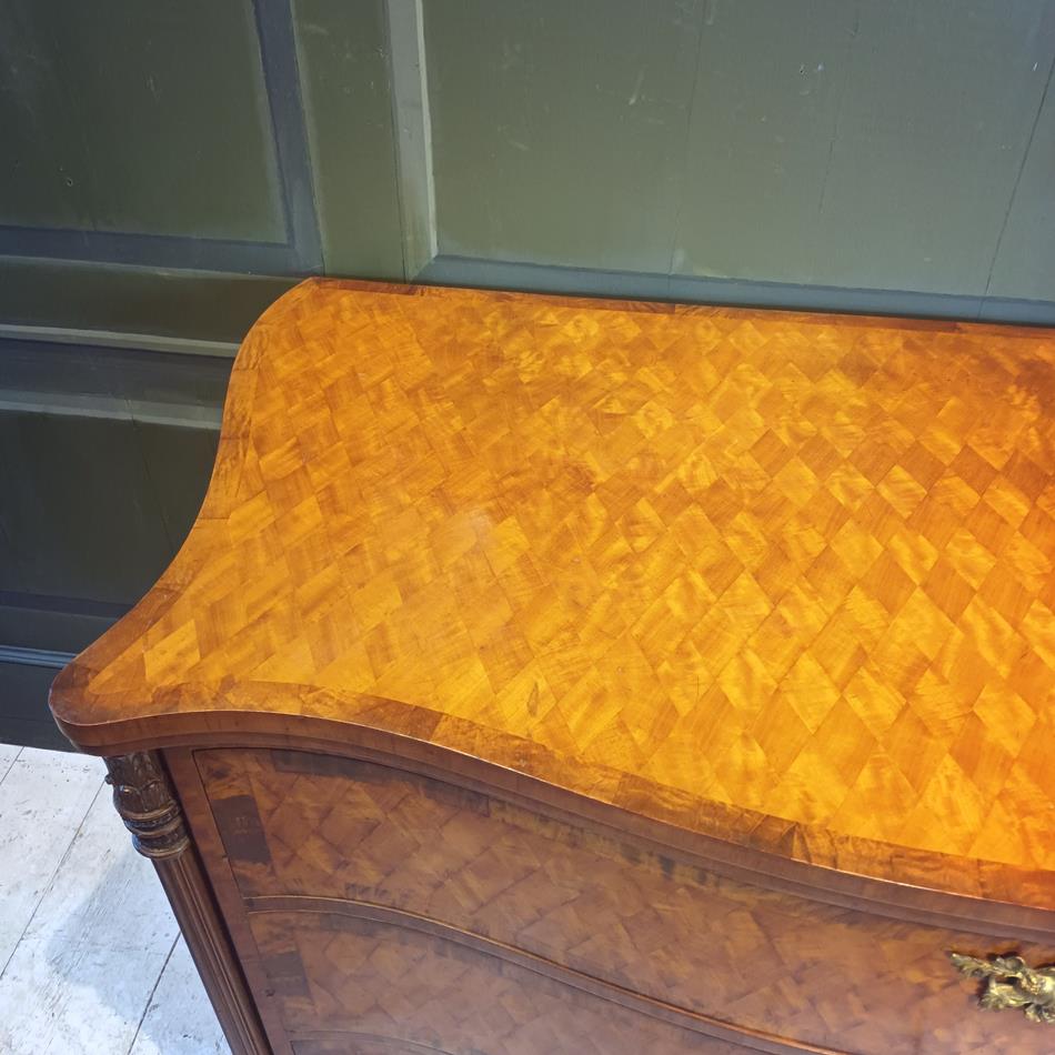 A Late 19th Century Serpentine Satinwood Commode