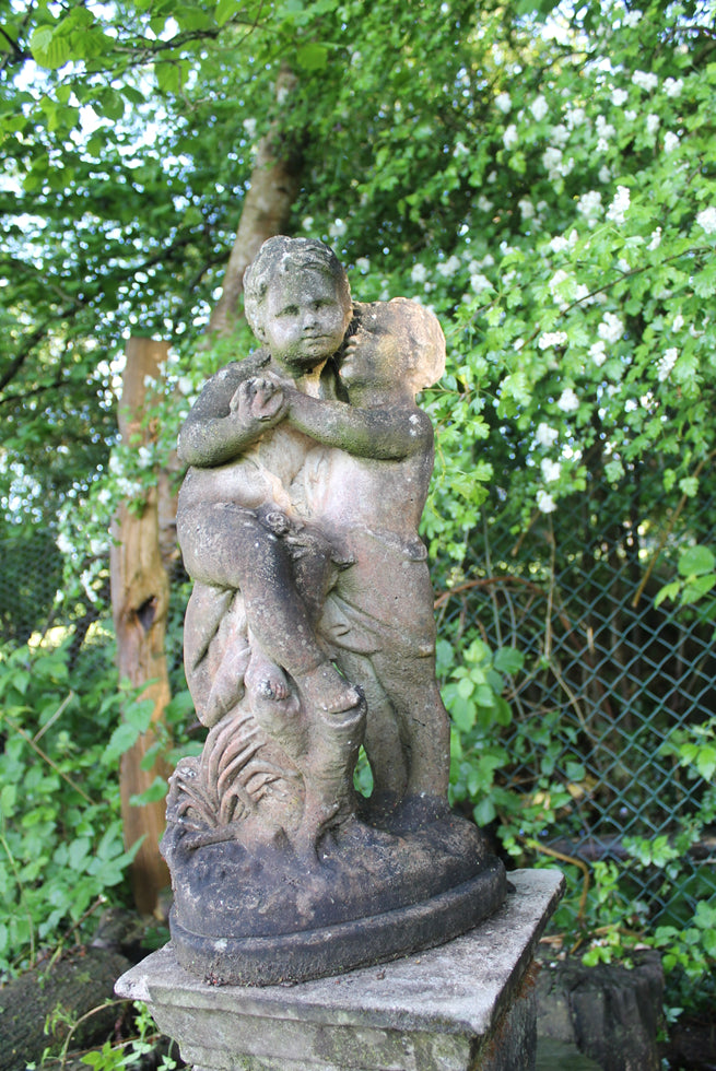 Statue Of Children On Plinth