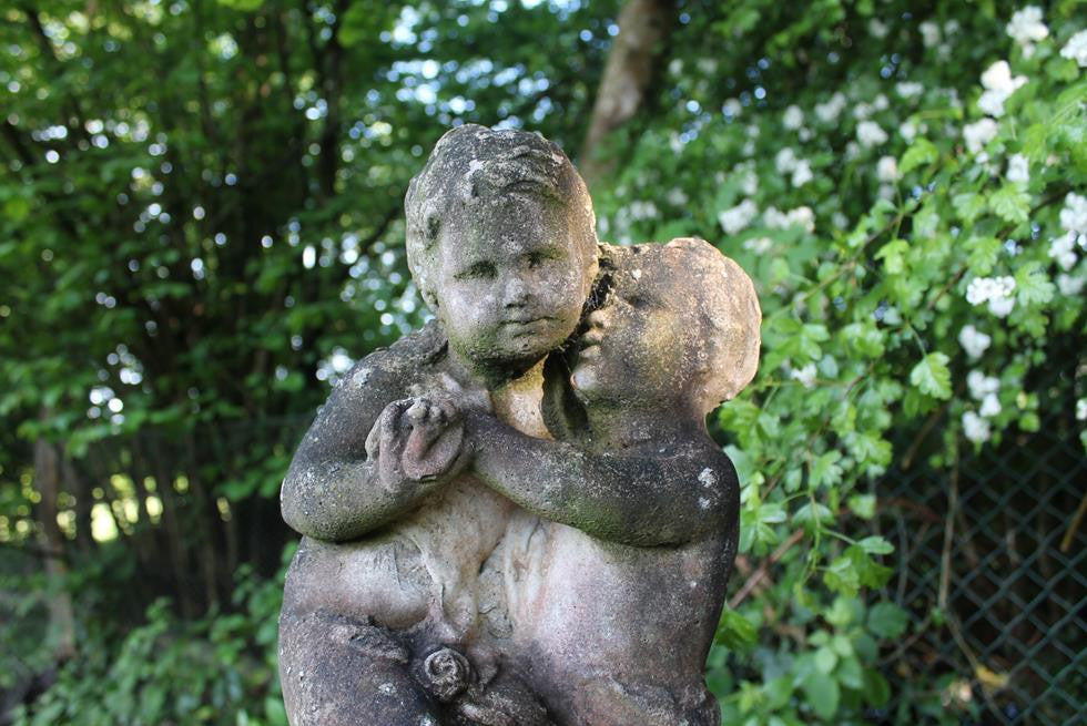 Statue Of Children On Plinth