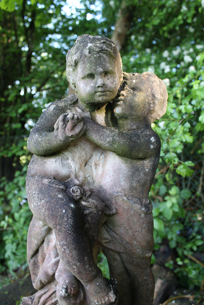 Statue Of Children On Plinth