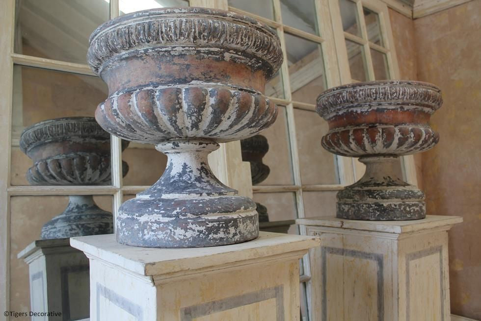 A Pair Of Victorian Urns On Plinths