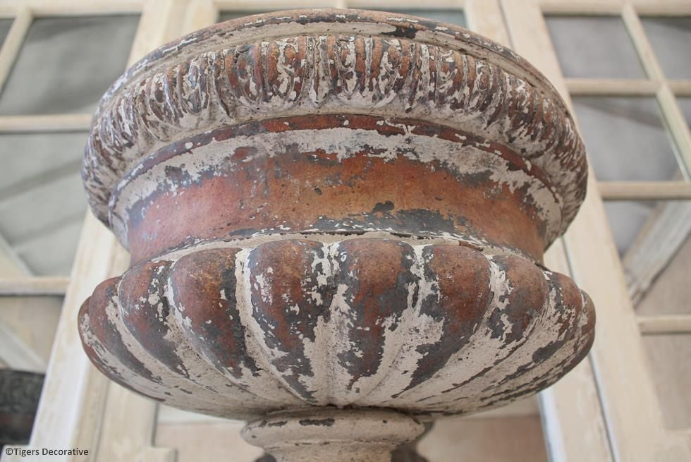 A Pair Of Victorian Urns On Plinths