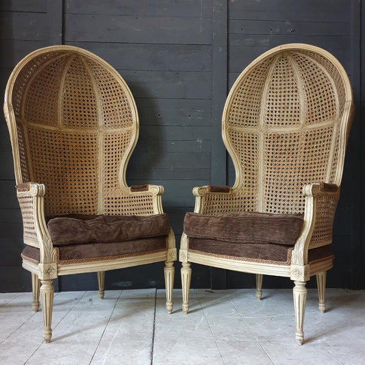 A Pair Of Caned Porters Chairs