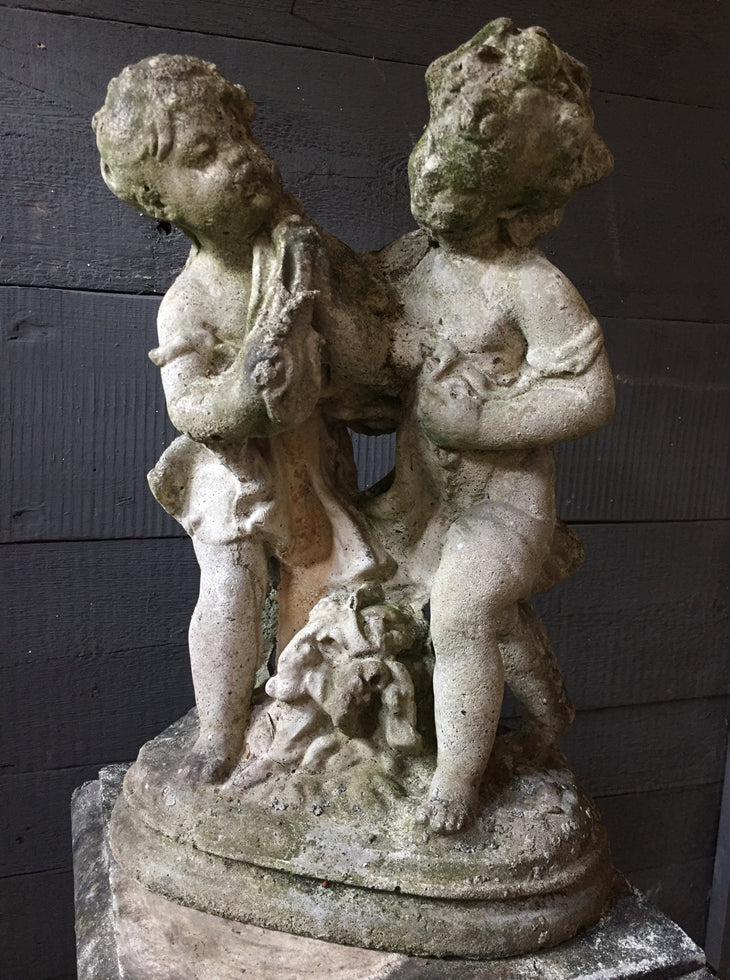 Statue Of Children On Plinth