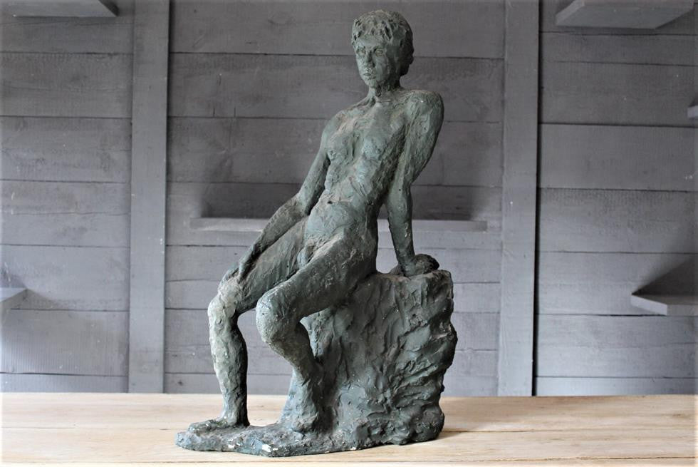 Seated Youth On Rocks Sculpture