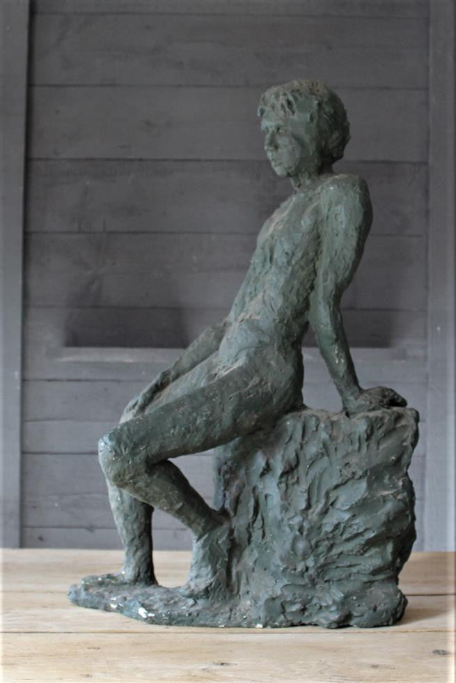 Seated Youth On Rocks Sculpture