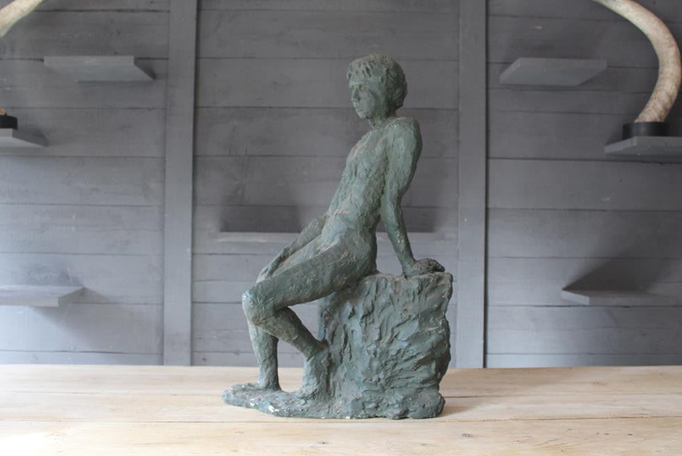 Seated Youth On Rocks Sculpture