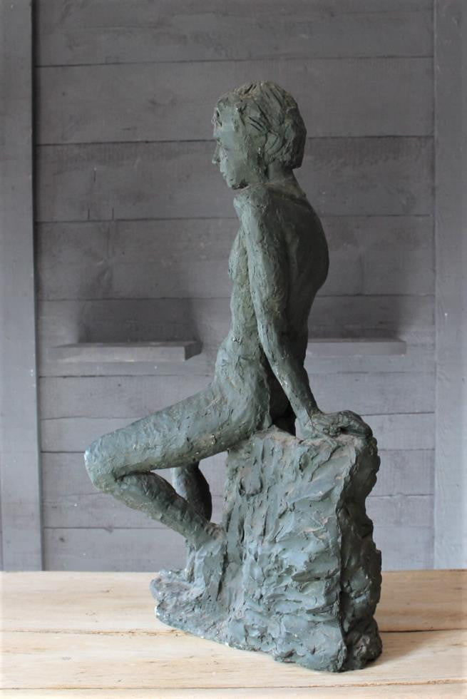 Seated Youth On Rocks Sculpture