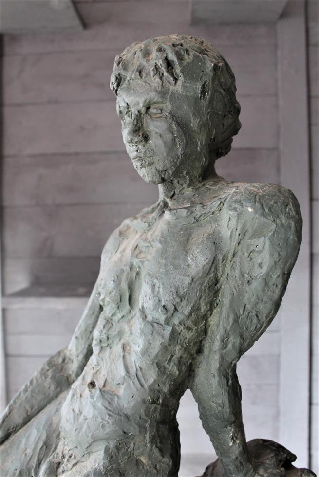 Seated Youth On Rocks Sculpture
