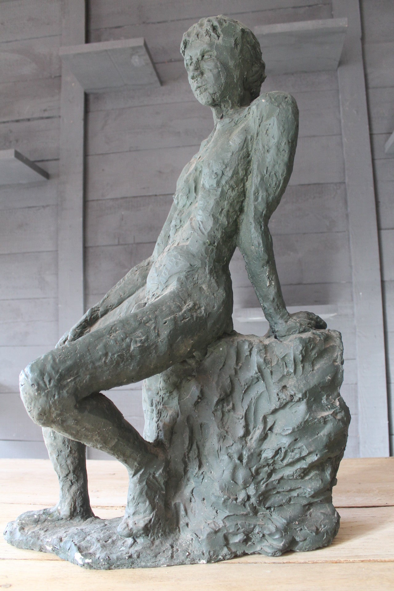 Seated Youth On Rocks Sculpture