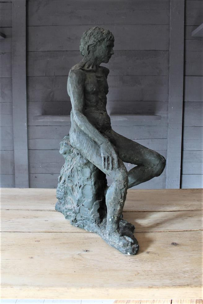 Seated Youth On Rocks Sculpture