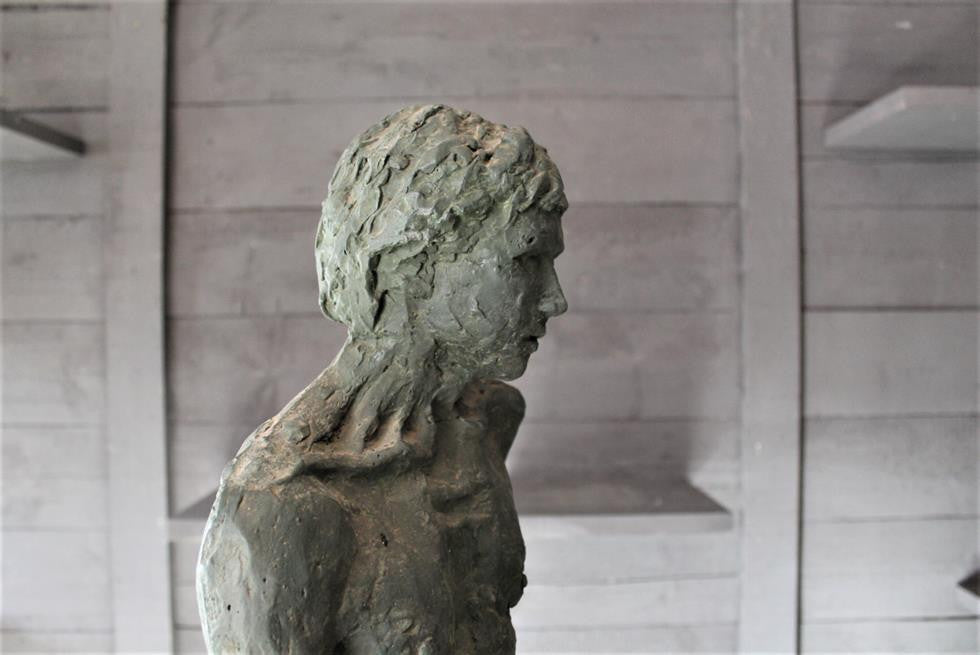 Seated Youth On Rocks Sculpture