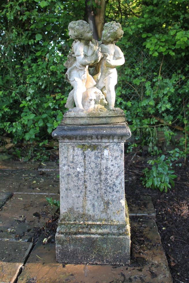 Statue Of Children On Plinth