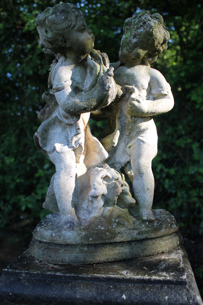 Statue Of Children On Plinth