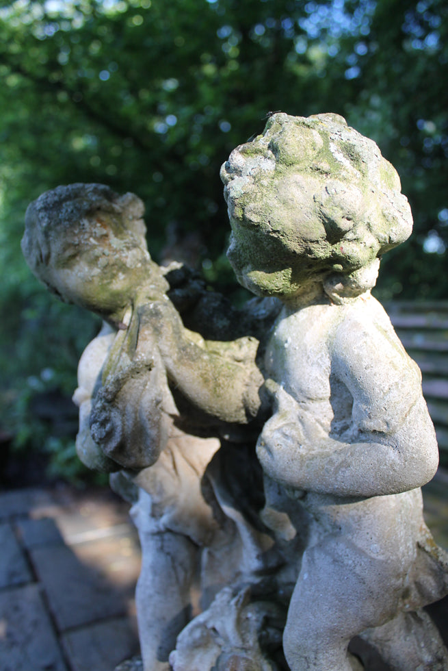 Statue Of Children On Plinth
