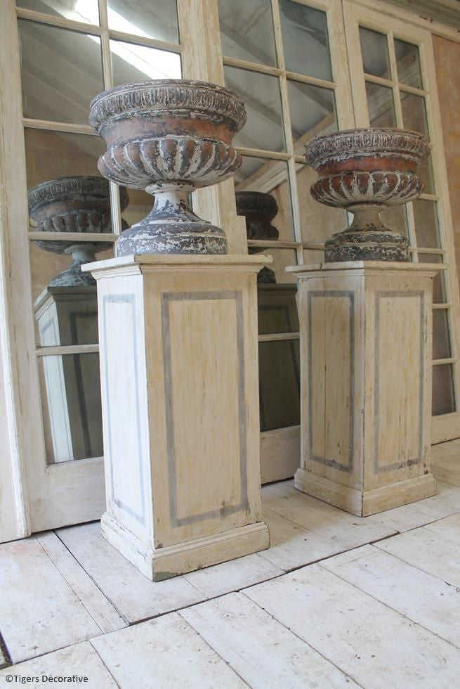 A Pair Of Victorian Urns On Plinths