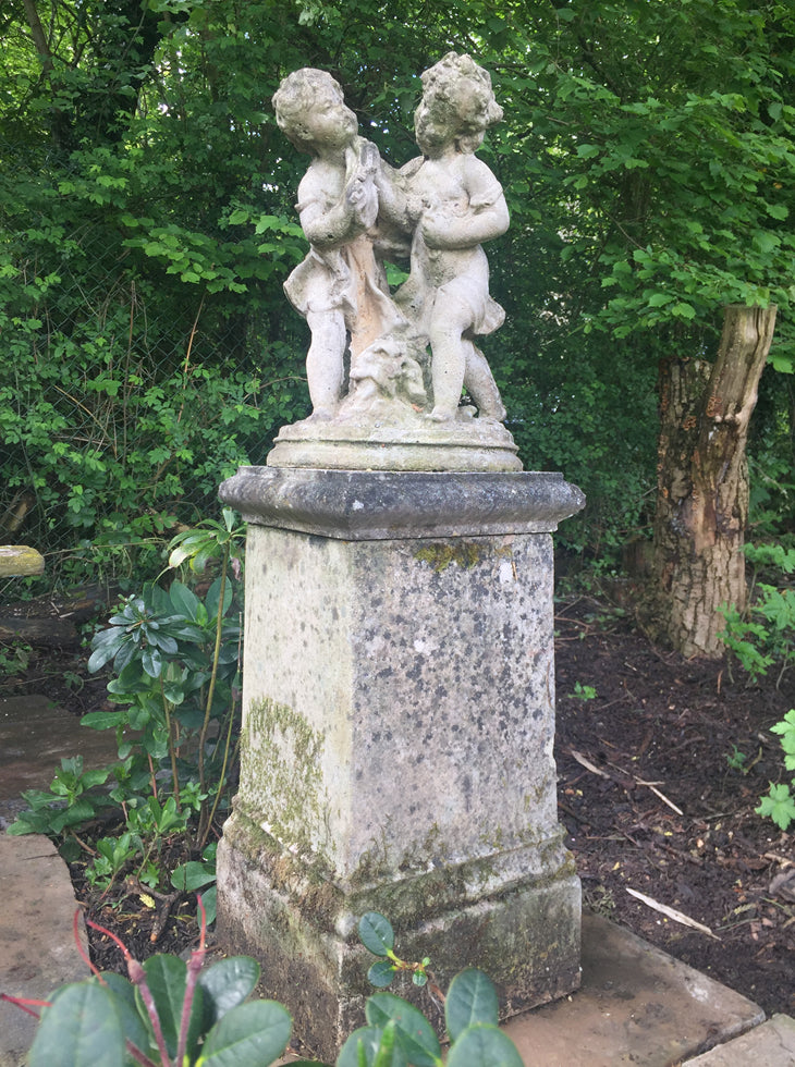 Statue Of Children On Plinth